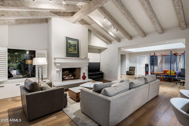 8312 N Golf Dr, Paradise Valley, AZ 85253 - living area featuring a warm lit fireplace, baseboards, wooden ceiling, vaulted ceiling with beams, and hardwood / wood-style flooring