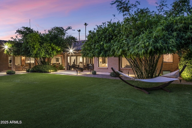8312 N Golf Dr, Paradise Valley, AZ 85253 - back of house with a patio, a yard, and brick siding