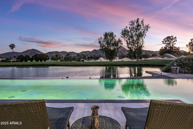 8312 N Golf Dr, Paradise Valley, AZ 85253 - pool at dusk featuring a water and mountain view