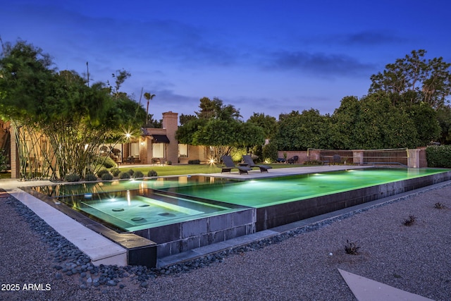 8312 N Golf Dr, Paradise Valley, AZ 85253 - pool at dusk with a jacuzzi