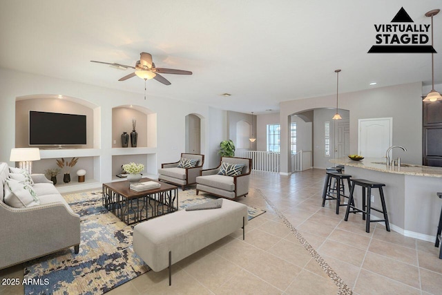 living room with built in features, light tile patterned floors, recessed lighting, a ceiling fan, and baseboards