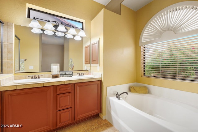 bathroom with tile patterned flooring, a bathing tub, and vanity