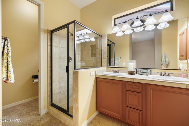 bathroom with vanity and a shower with shower door