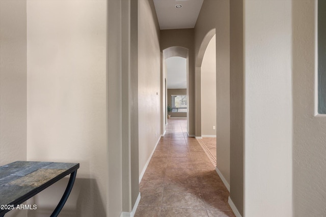 hall with light tile patterned floors