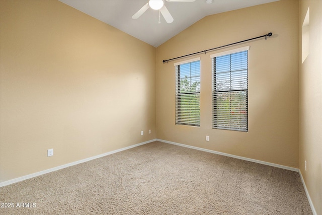 carpeted empty room with vaulted ceiling and ceiling fan