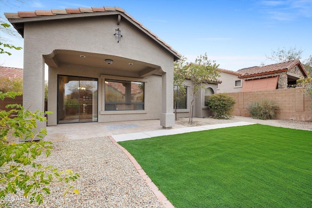 back of house featuring a yard and a patio