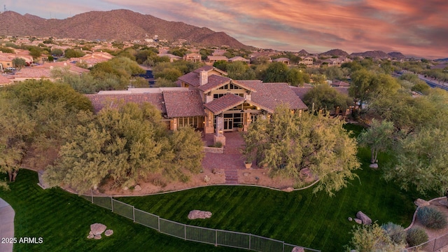 aerial view at dusk featuring a mountain view