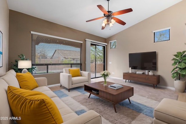 carpeted living room with vaulted ceiling and ceiling fan