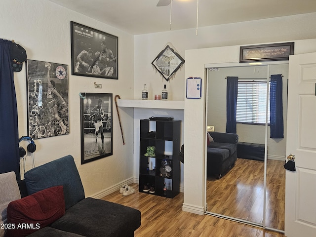 living area with ceiling fan and hardwood / wood-style floors