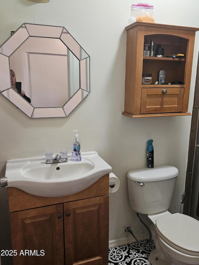 bathroom featuring toilet and vanity