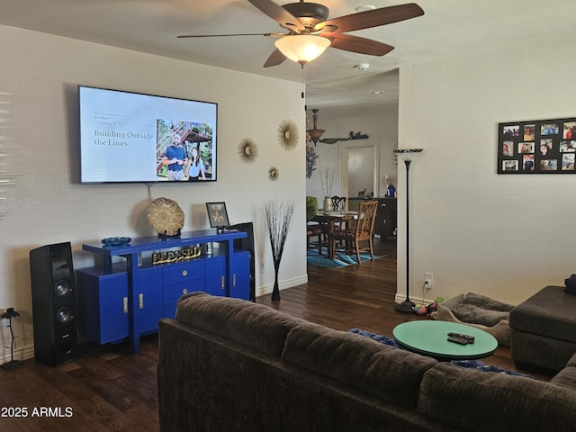 living room with ceiling fan and dark wood-type flooring