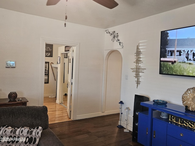 interior space featuring ceiling fan and dark wood-type flooring