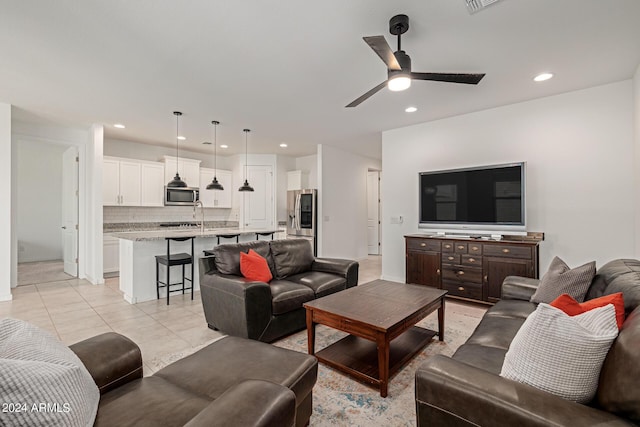 tiled living room featuring ceiling fan