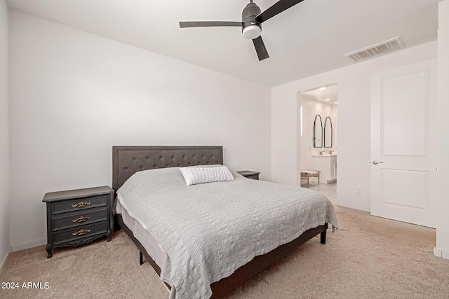 carpeted bedroom with ceiling fan and connected bathroom