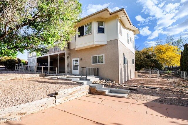 11180 E Navajo Dr, Dewey, AZ 86327 - back of property with fence, stucco siding, and a patio area