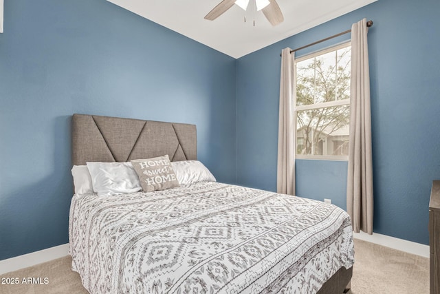 carpeted bedroom featuring a ceiling fan and baseboards