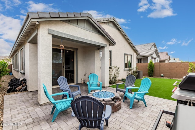 view of patio with grilling area, an outdoor fire pit, and fence