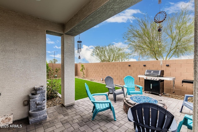 view of patio / terrace with area for grilling and a fenced backyard