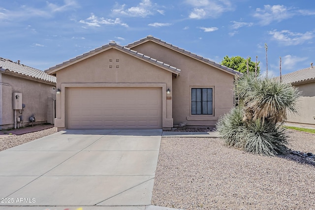 ranch-style home with concrete driveway, an attached garage, stucco siding, and a tiled roof