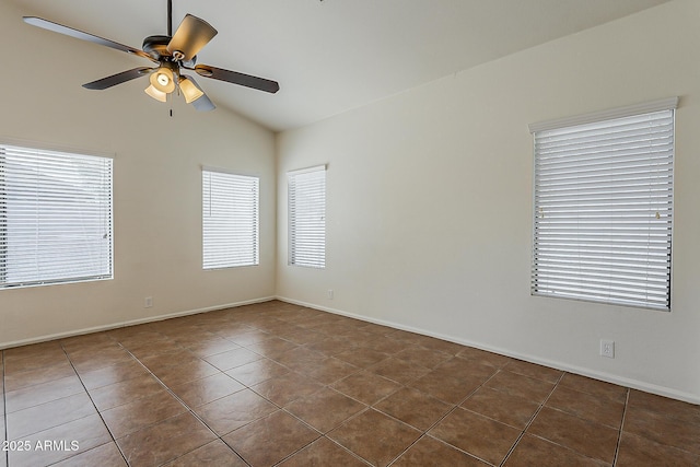 spare room featuring ceiling fan, lofted ceiling, baseboards, and tile patterned floors