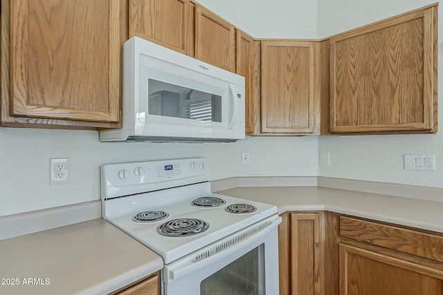 kitchen featuring white appliances and light countertops