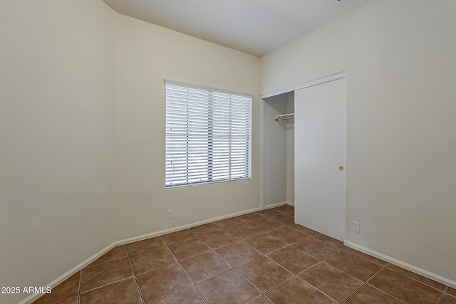 unfurnished bedroom featuring a closet and tile patterned flooring