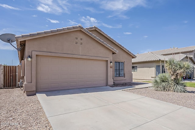 ranch-style home with concrete driveway, a garage, stucco siding, and a tiled roof