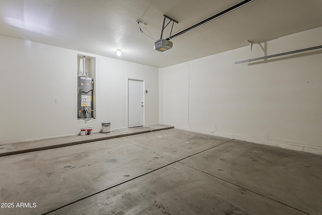 garage featuring water heater and a garage door opener