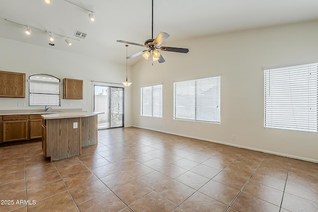kitchen featuring a sink, a ceiling fan, visible vents, and tile patterned floors
