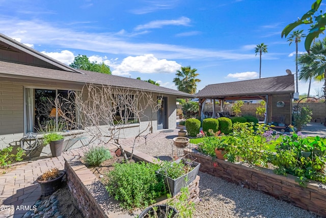 exterior space with a garden and fence