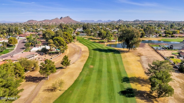 aerial view featuring a water and mountain view and view of golf course