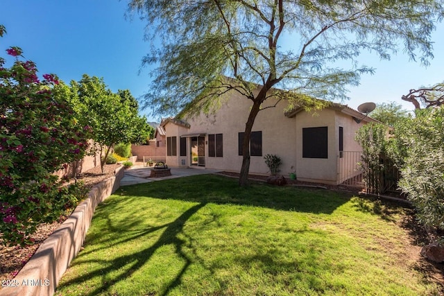 6970 W Paso Trl, Peoria, AZ 85383 - rear view of property with a lawn, a fire pit, stucco siding, and a patio area