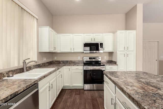 6970 W Paso Trl, Peoria, AZ 85383 - kitchen featuring dark stone counters, white cabinets, a sink, appliances with stainless steel finishes, and dark wood-style flooring