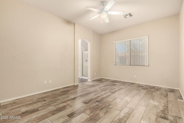 6970 W Paso Trl, Peoria, AZ 85383 - unfurnished room with wood finished floors, visible vents, a ceiling fan, and arched walkways