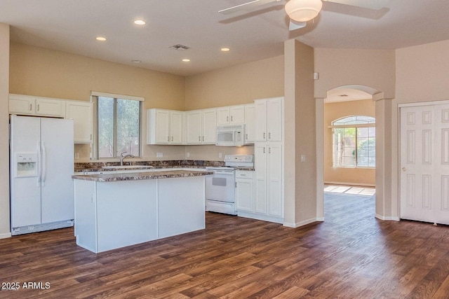 6970 W Paso Trl, Peoria, AZ 85383 - kitchen featuring a sink, a ceiling fan, white cabinetry, white appliances, and arched walkways
