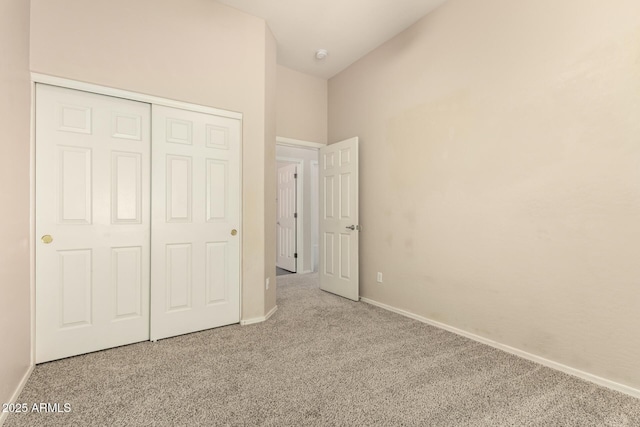 6970 W Paso Trl, Peoria, AZ 85383 - unfurnished bedroom featuring baseboards, carpet floors, lofted ceiling, and a closet