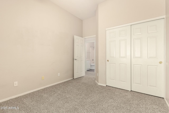 6970 W Paso Trl, Peoria, AZ 85383 - unfurnished bedroom with lofted ceiling, a closet, carpet flooring, and baseboards