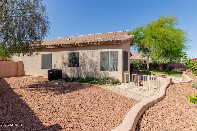 6970 W Paso Trl, Peoria, AZ 85383 - back of house with stucco siding, a tiled roof, central air condition unit, and a fenced backyard