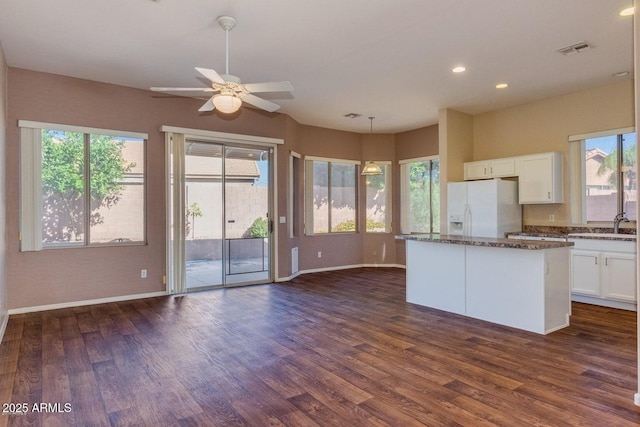 6970 W Paso Trl, Peoria, AZ 85383 - kitchen featuring white fridge with ice dispenser, dark wood-style flooring, and plenty of natural light