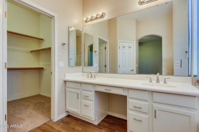 6970 W Paso Trl, Peoria, AZ 85383 - full bath with double vanity, wood finished floors, a walk in closet, and a sink
