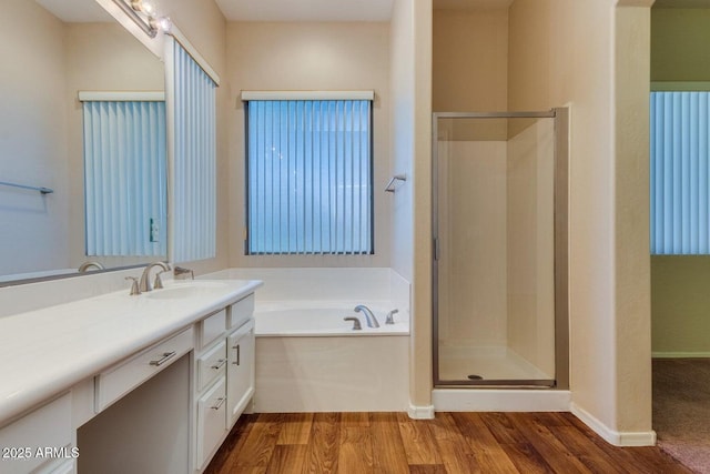 6970 W Paso Trl, Peoria, AZ 85383 - full bathroom featuring a garden tub, a stall shower, wood finished floors, and vanity