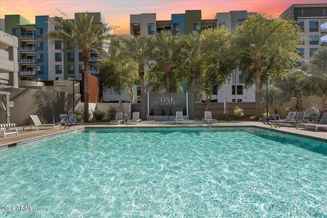 view of pool at dusk