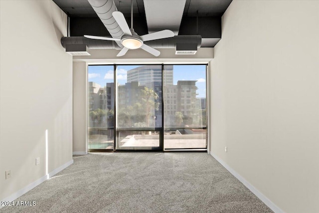 unfurnished room featuring ceiling fan and carpet floors