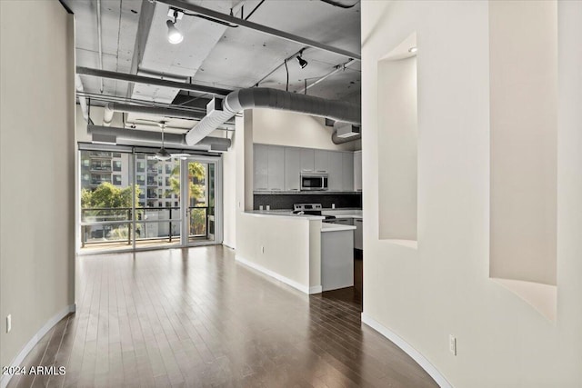 kitchen featuring hardwood / wood-style flooring, stainless steel appliances, and backsplash