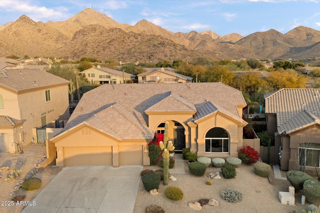 view of front of home featuring a mountain view and a garage