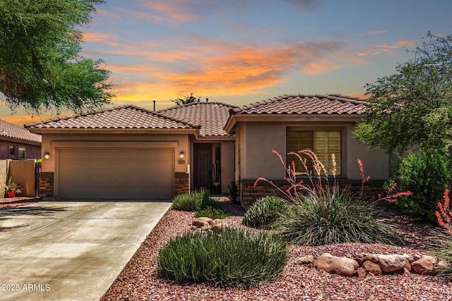 7617 E Desert Honeysuckle Dr, Gold Canyon, AZ 85118 - mediterranean / spanish-style house featuring an attached garage, stucco siding, driveway, and a tiled roof