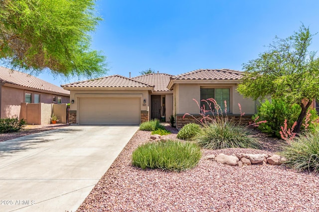 7617 E Desert Honeysuckle Dr, Gold Canyon, AZ 85118 - mediterranean / spanish home with an attached garage, stucco siding, driveway, stone siding, and a tiled roof