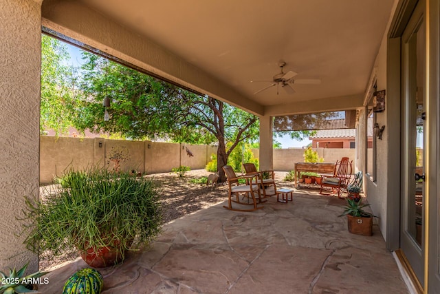 7617 E Desert Honeysuckle Dr, Gold Canyon, AZ 85118 - fenced backyard with ceiling fan, a patio, and an outdoor living space