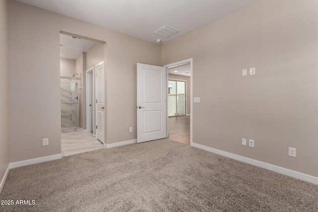 5656 N 205th Ln, Buckeye, AZ 85396 - unfurnished bedroom with carpet floors, baseboards, and connected bathroom