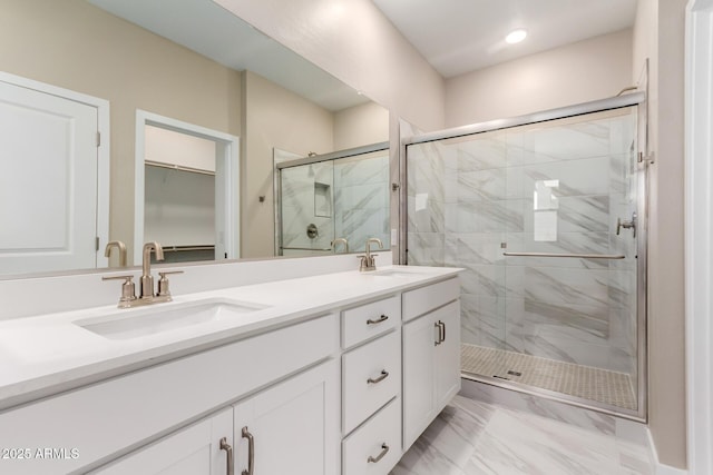 5656 N 205th Ln, Buckeye, AZ 85396 - full bathroom with a stall shower, double vanity, a walk in closet, and marble finish flooring